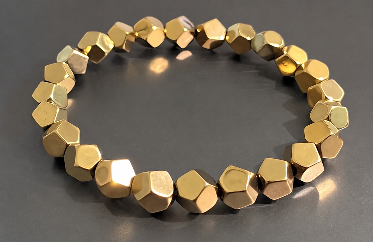 Bracelet with faceted metallic gold-tone beads